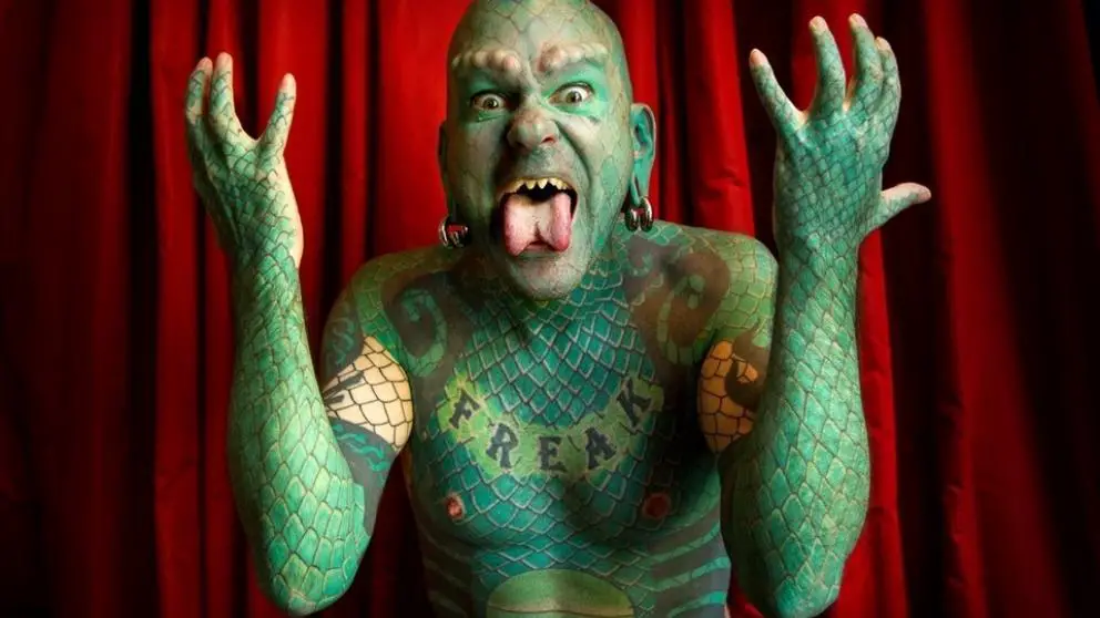 most body modifications: lizard man tattoo